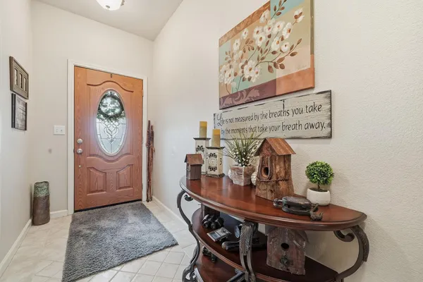 a view of a hallway with furniture