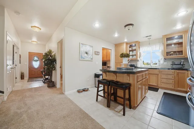 a kitchen with granite countertop a sink and cabinets