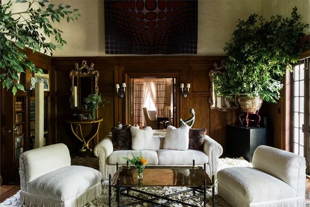 a living room with furniture and a potted plant