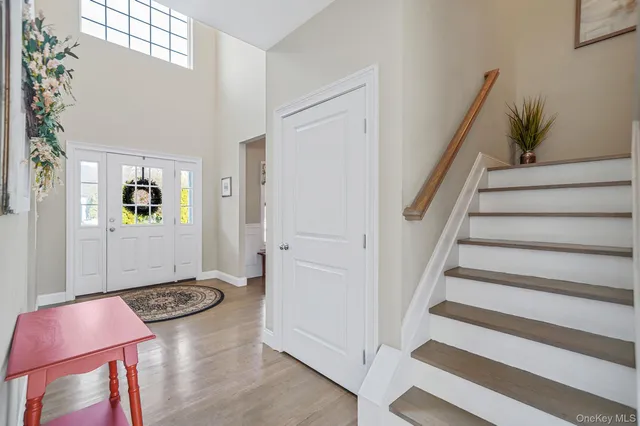 a view of a hallway with furniture and staircase