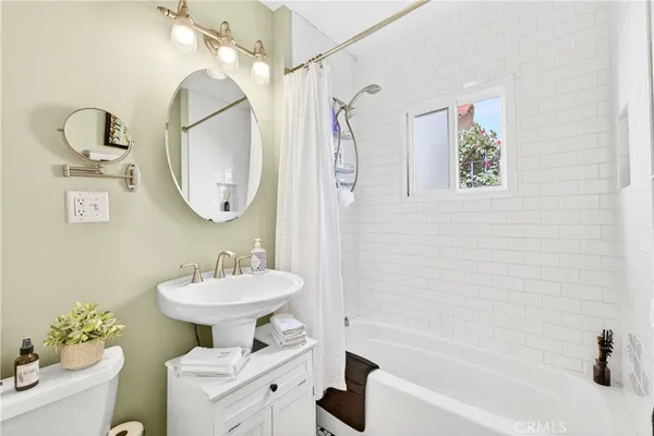 a bathroom with a sink toilet and a mirror