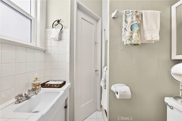 a bathroom with a sink a toilet and mirror