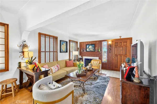 a living room with furniture and a floor to ceiling window