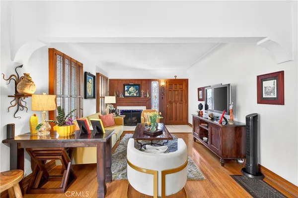 a living room with furniture a flat screen tv and a large window