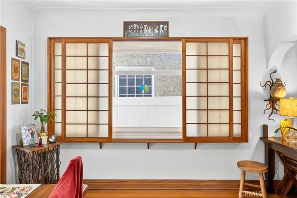 a living room with furniture and large window