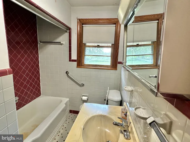 a bathroom with a sink a toilet and tub