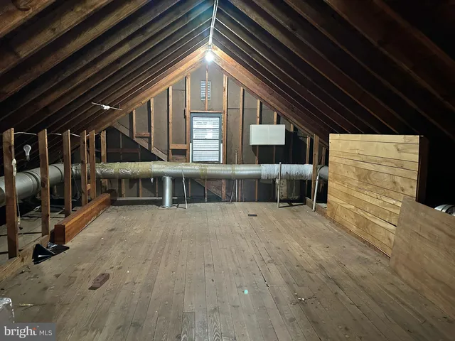 a view of a house with wooden deck and furniture