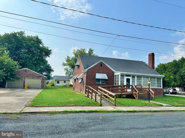 a front view of a house with a yard table and chairs