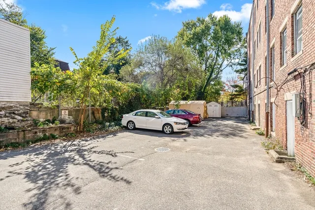 a view of a house with a yard and sitting area