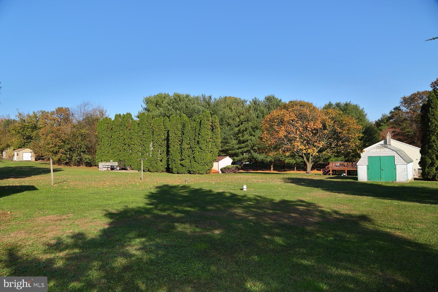 1007 East Meadow Road Manheim, PA 17545 - Photo 2 of 28 a backyard of a house with table and chairs under an umbrella