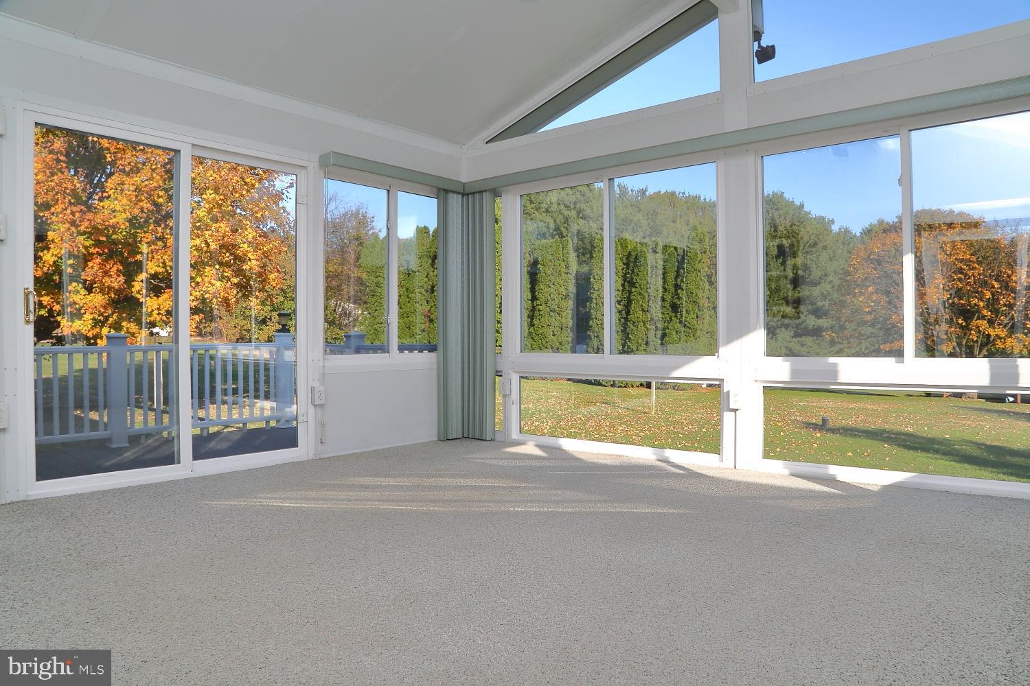 1007 East Meadow Road Manheim, PA 17545 - Photo 17 of 28 a view of an empty room with wooden floor and a large window