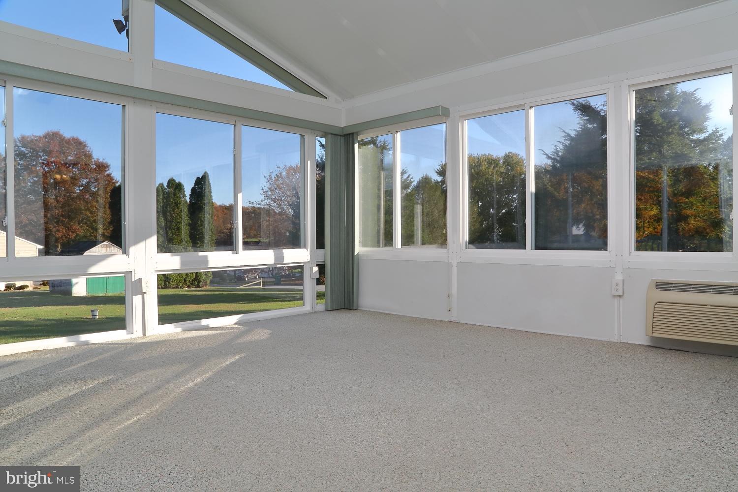 1007 East Meadow Road Manheim, PA 17545 - Photo 18 of 28 a view of a building with a floor to ceiling window and a tree