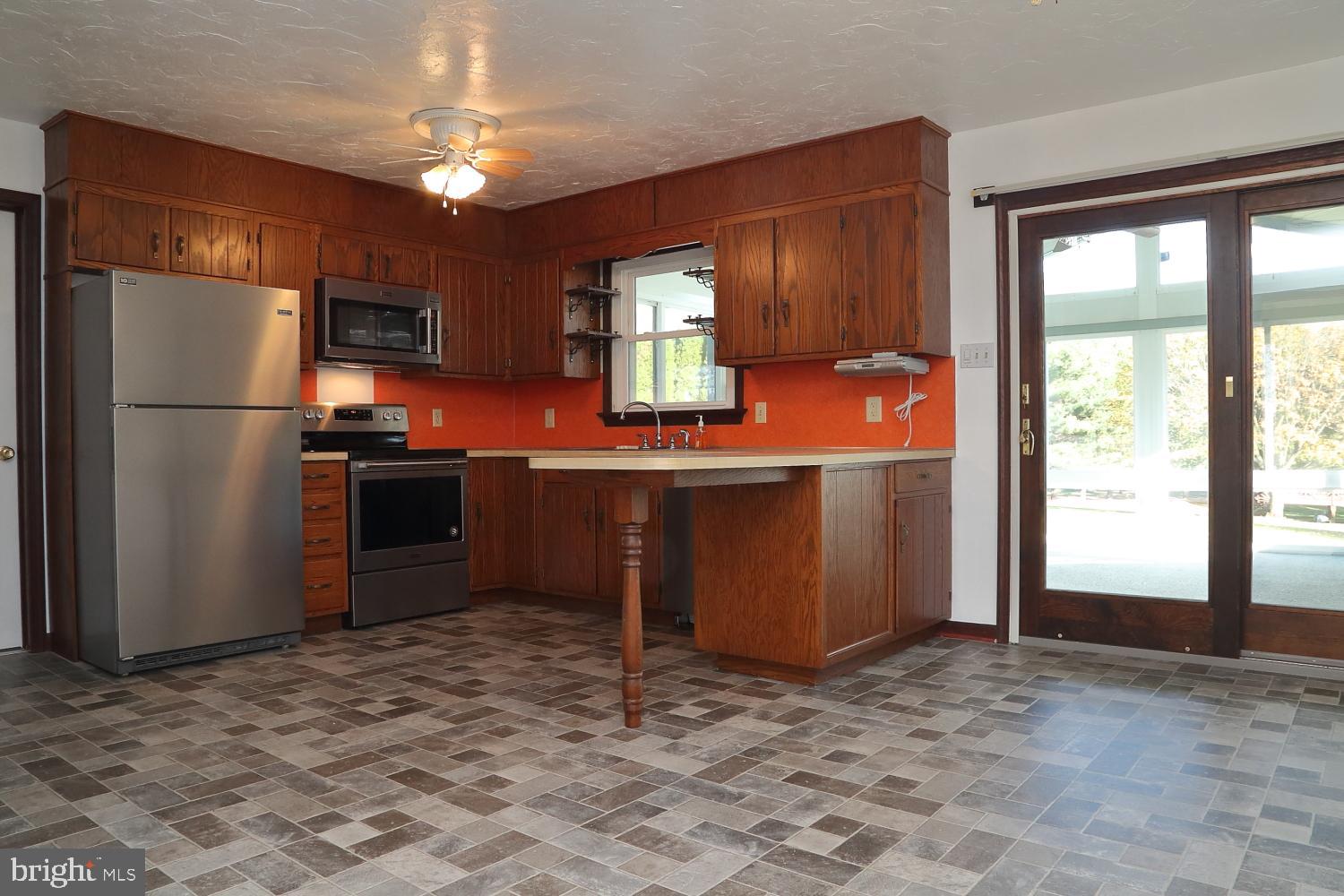 1007 East Meadow Road Manheim, PA 17545 - Photo 22 of 28 a kitchen with stainless steel appliances granite countertop a refrigerator a stove a sink and dishwasher