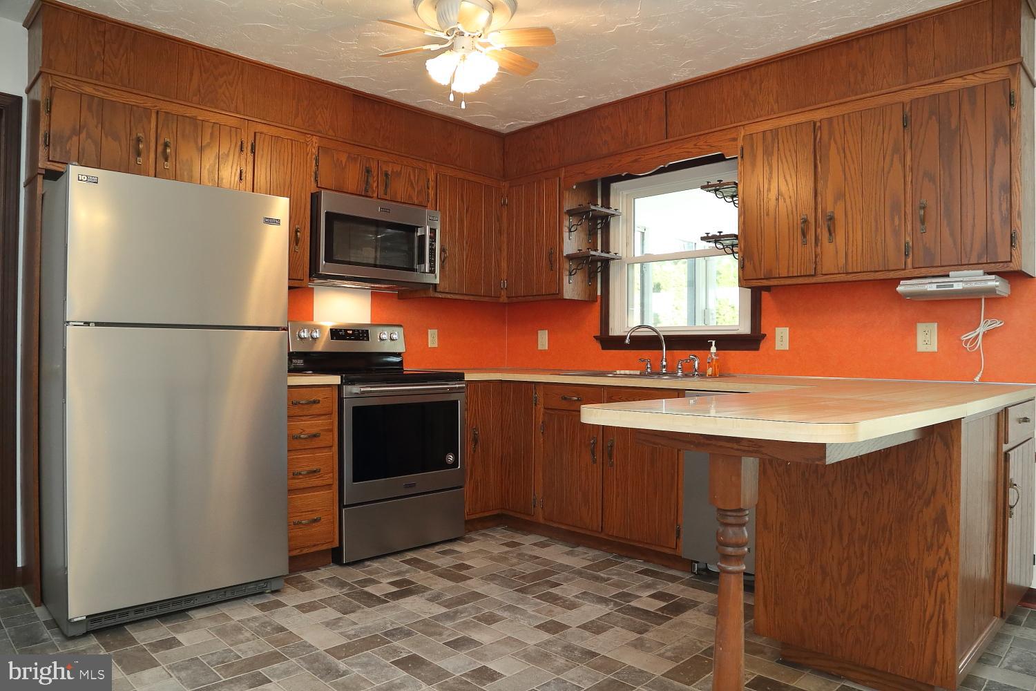 1007 East Meadow Road Manheim, PA 17545 - Photo 24 of 28 a kitchen with stainless steel appliances granite countertop a refrigerator a stove a sink and a microwave