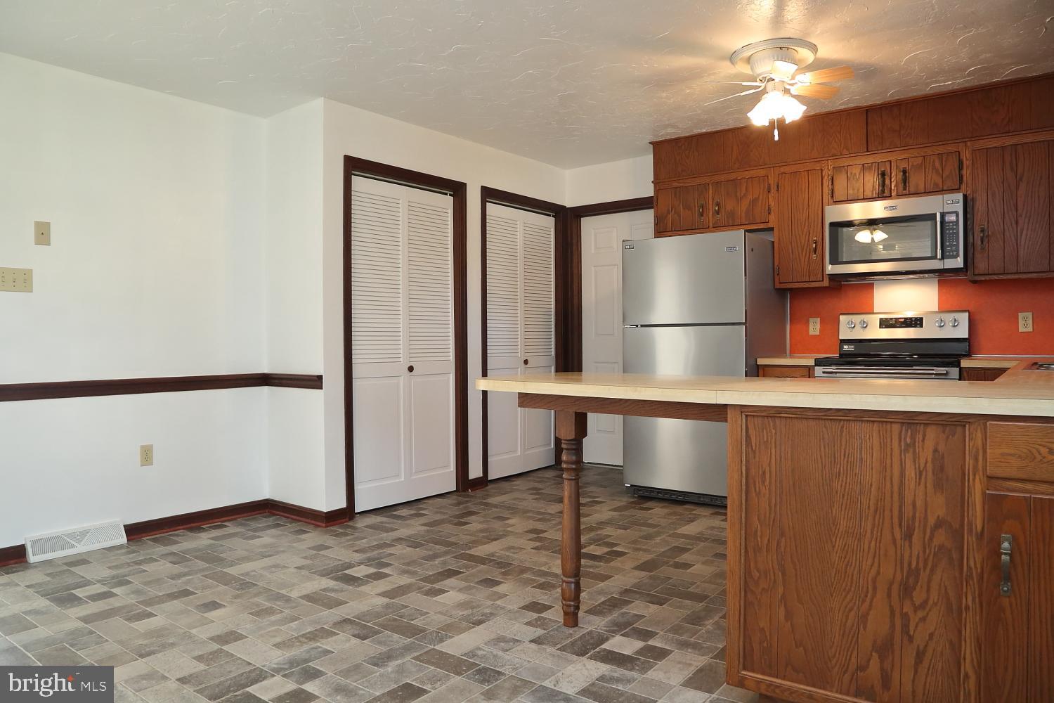 1007 East Meadow Road Manheim, PA 17545 - Photo 25 of 28 a kitchen with stainless steel appliances a refrigerator and a stove top oven