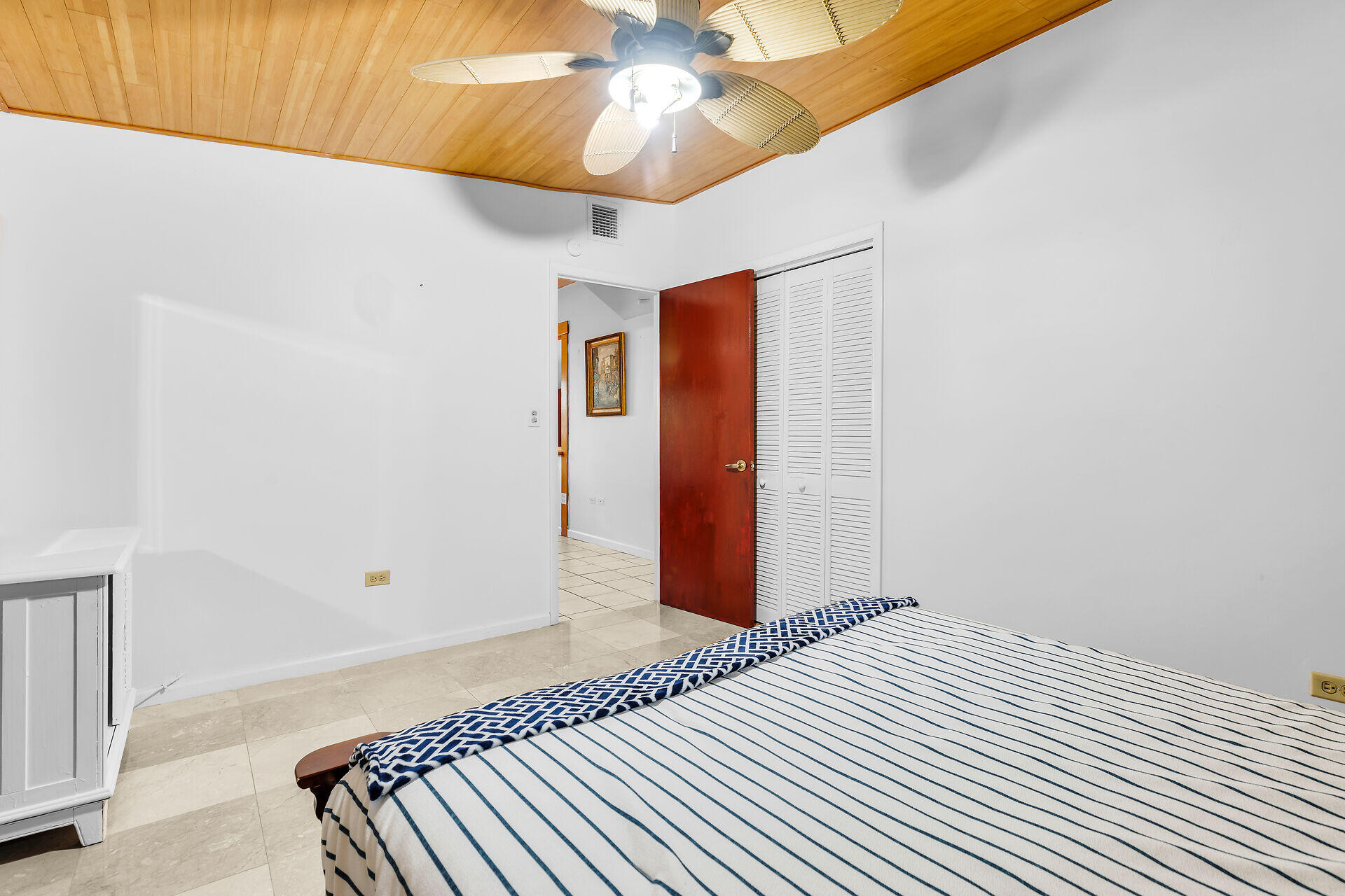 13 Bass Avenue Key Largo, FL 33037 - Photo 20 of 43 a bedroom with a bed and a chandelier