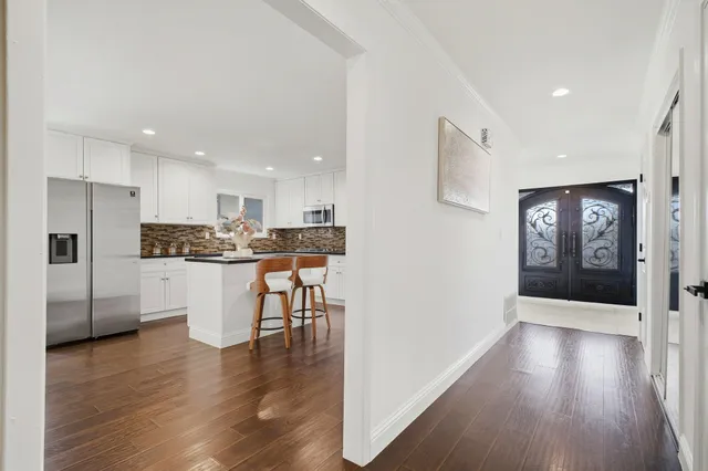 a view of kitchen with stainless steel appliances refrigerator microwave and stove
