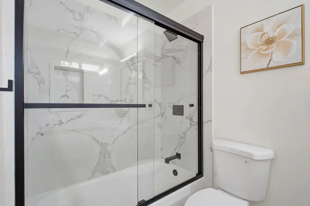 a bathroom with a shower and toilet