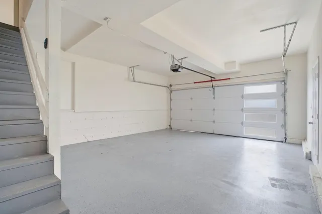 a view of a room with white walls and entryway