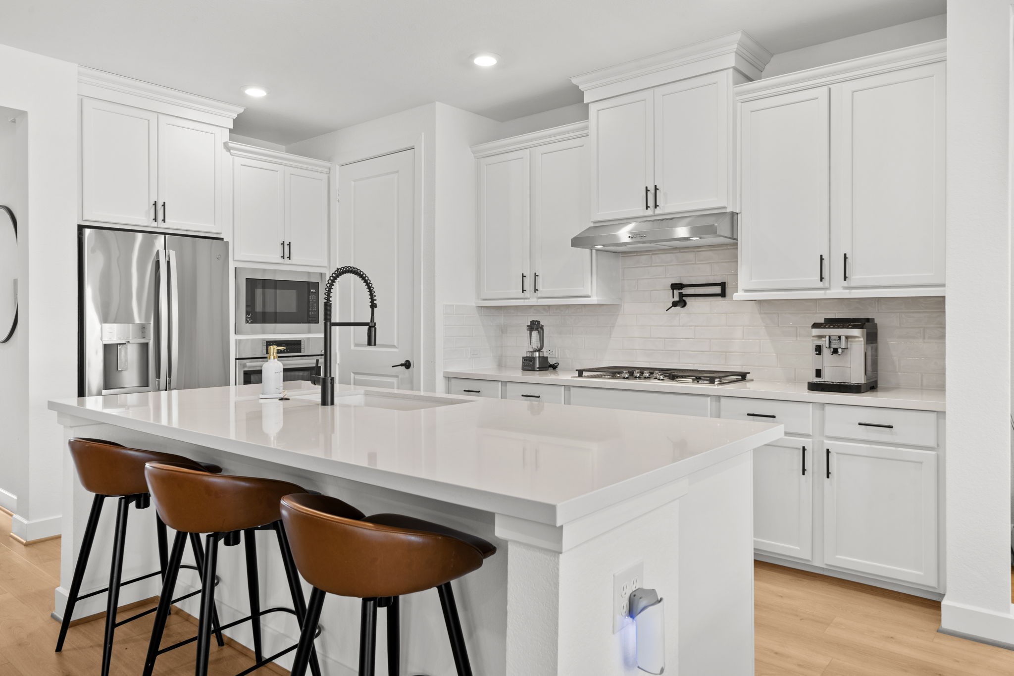29154 Rustic Orch Lane Fulshear, TX 77441 - Photo 15 of 35 a kitchen with stainless steel appliances granite countertop a table chairs sink and cabinets