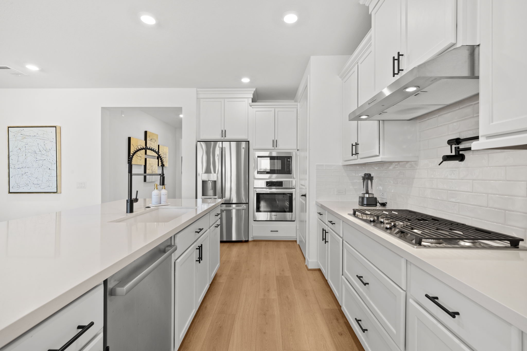 29154 Rustic Orch Lane Fulshear, TX 77441 - Photo 16 of 35 a large kitchen with stainless steel appliances kitchen island a white stove top oven and a sink with cabinets