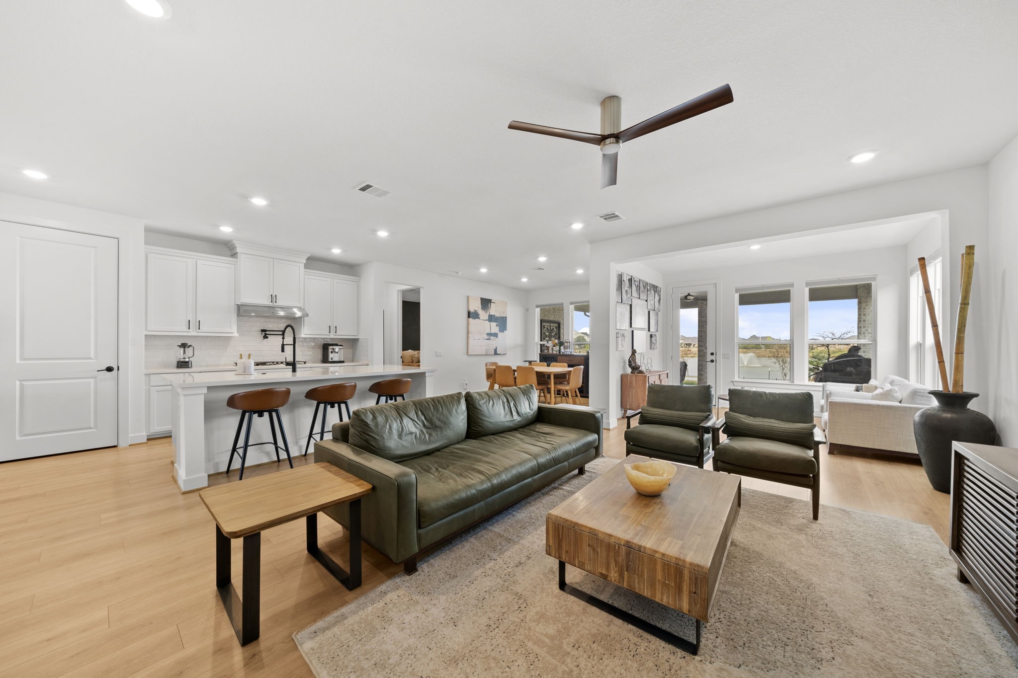 29154 Rustic Orch Lane Fulshear, TX 77441 - Photo 18 of 35 a view of living room kitchen with furniture and a wooden floor