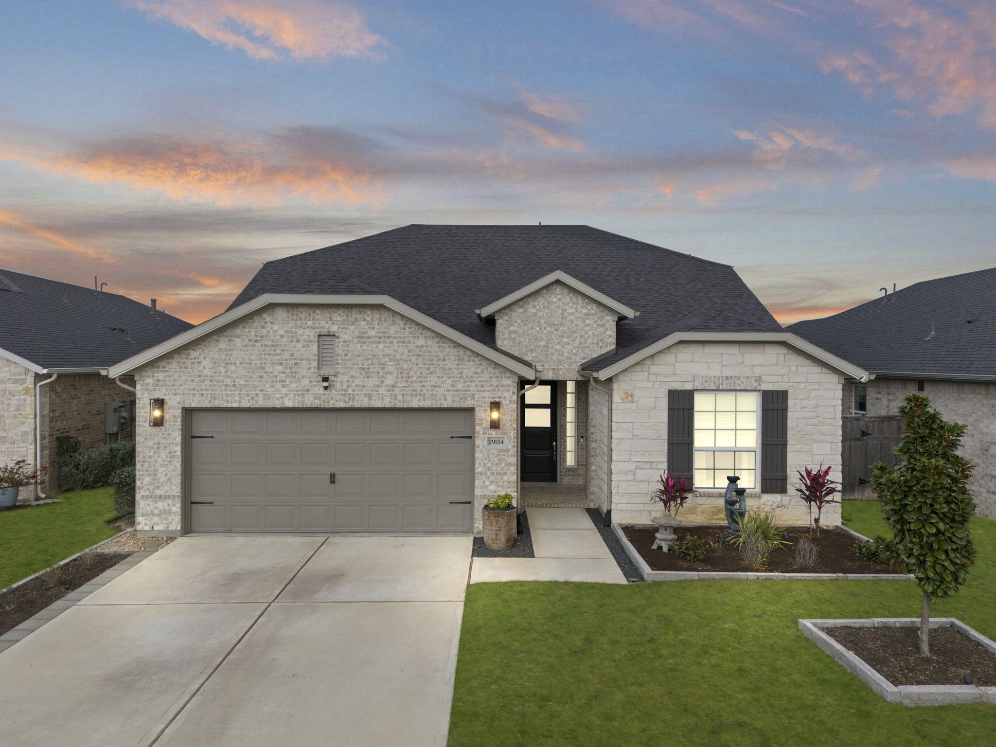 29154 Rustic Orch Lane Fulshear, TX 77441 - Photo 2 of 35 a view of a house with a yard plants and a large tree