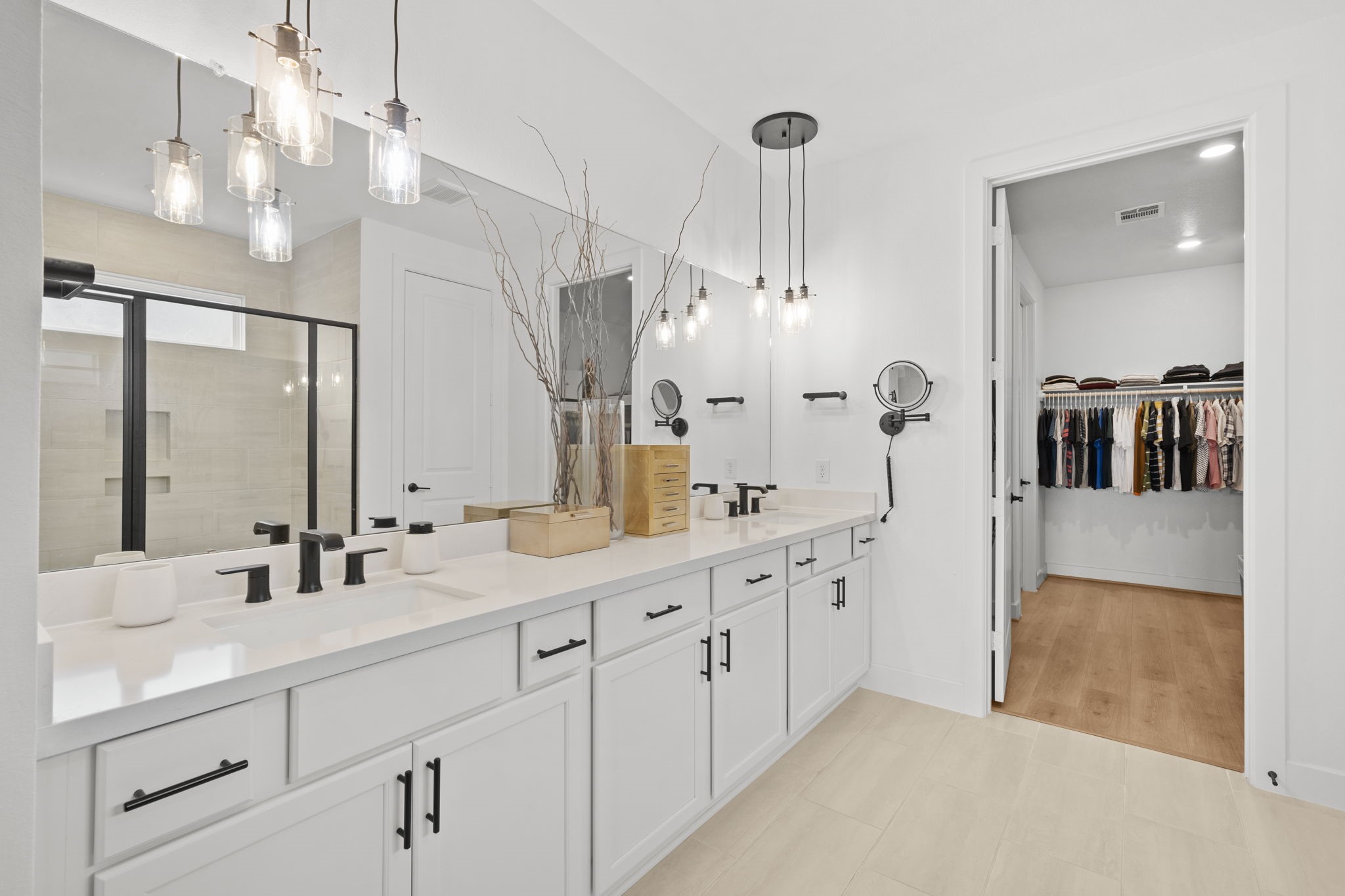 29154 Rustic Orch Lane Fulshear, TX 77441 - Photo 29 of 35 a spacious bathroom with double vanity a sink a mirror and shower