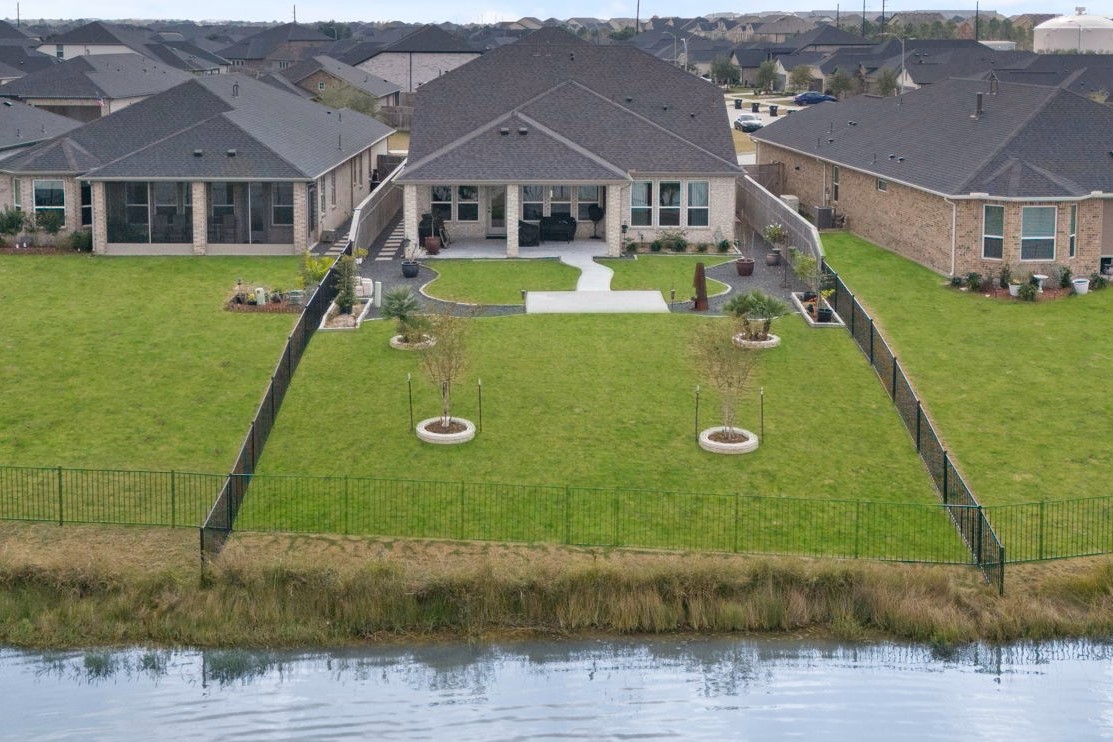 29154 Rustic Orch Lane Fulshear, TX 77441 - Photo 32 of 35 a view of a big house with a big yard