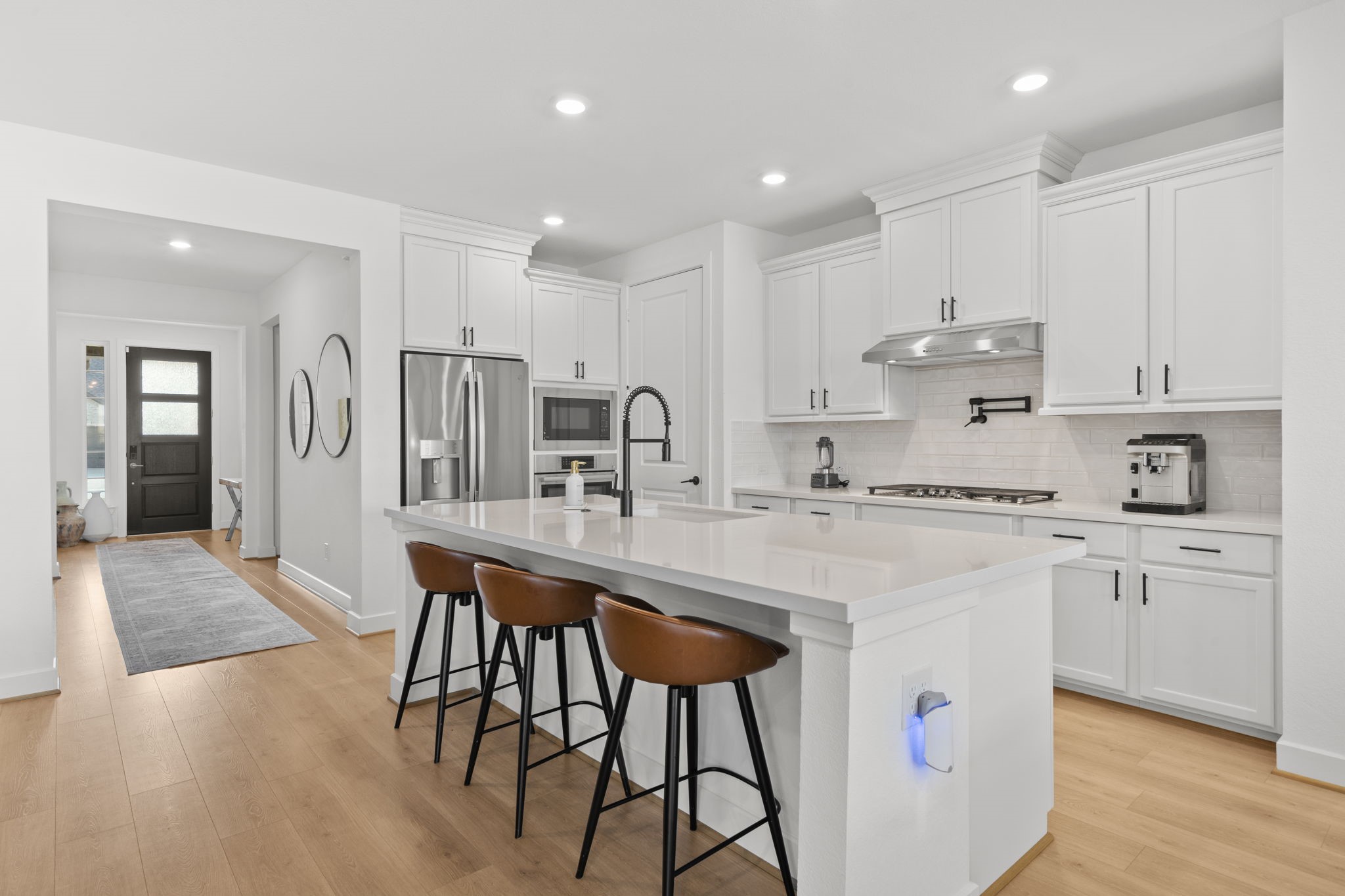 29154 Rustic Orch Lane Fulshear, TX 77441 - Photo 4 of 35 a kitchen with stainless steel appliances granite countertop a white cabinets and chairs
