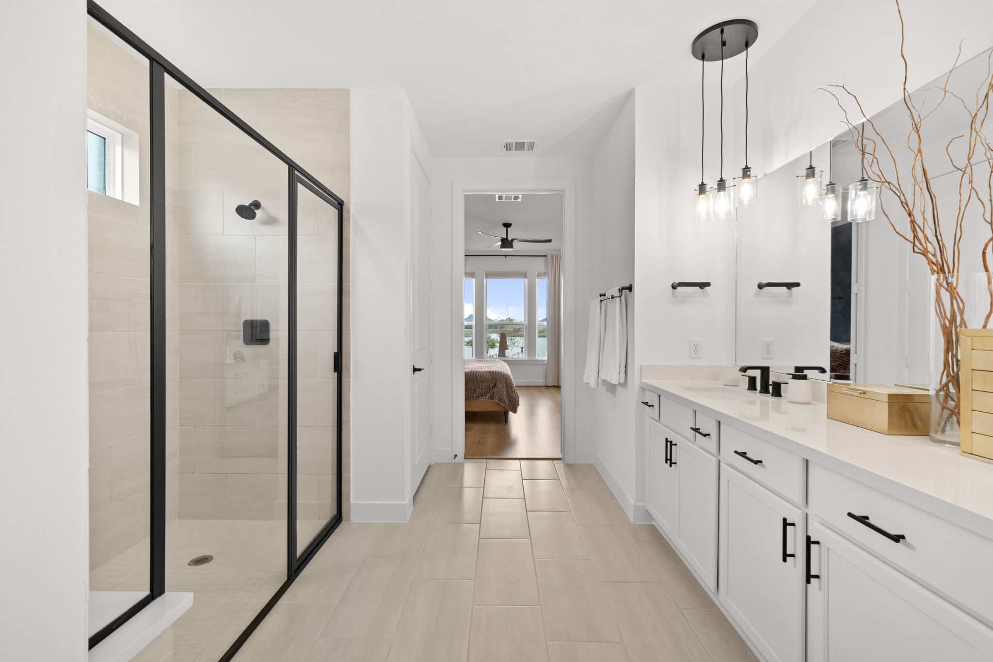 29154 Rustic Orch Lane Fulshear, TX 77441 - Photo 9 of 35 a bathroom with a double vanity sink and mirror with shower