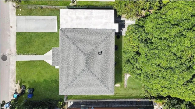 an aerial view of a house with a yard