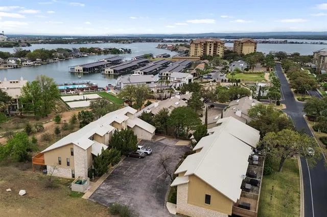 an aerial view of a house with outdoor space and lake view in back