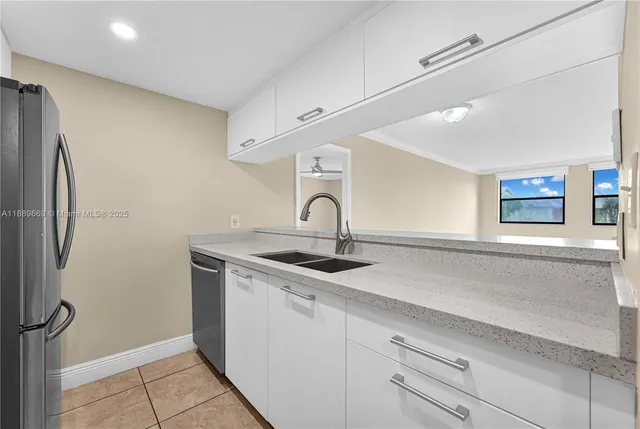 a kitchen with a sink and refrigerator