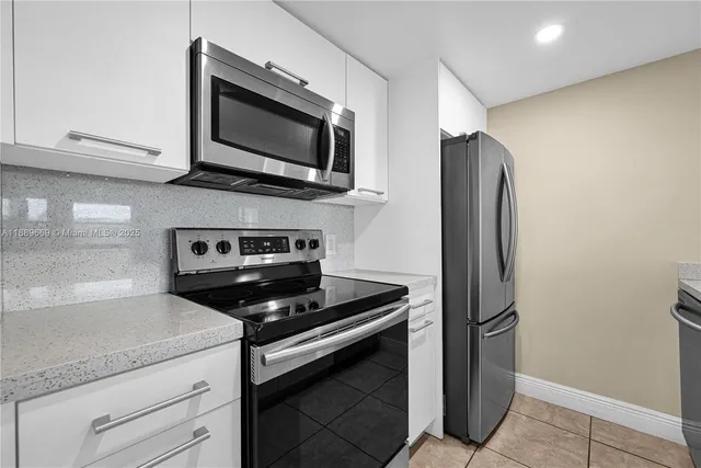 a kitchen with stainless steel appliances a stove microwave and sink