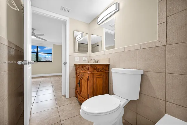 a white toilet sitting next to a bathroom sink