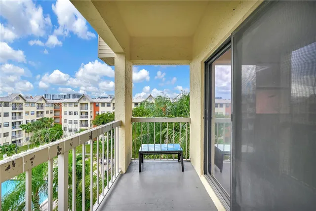 a view of a glass door with a balcony from a window