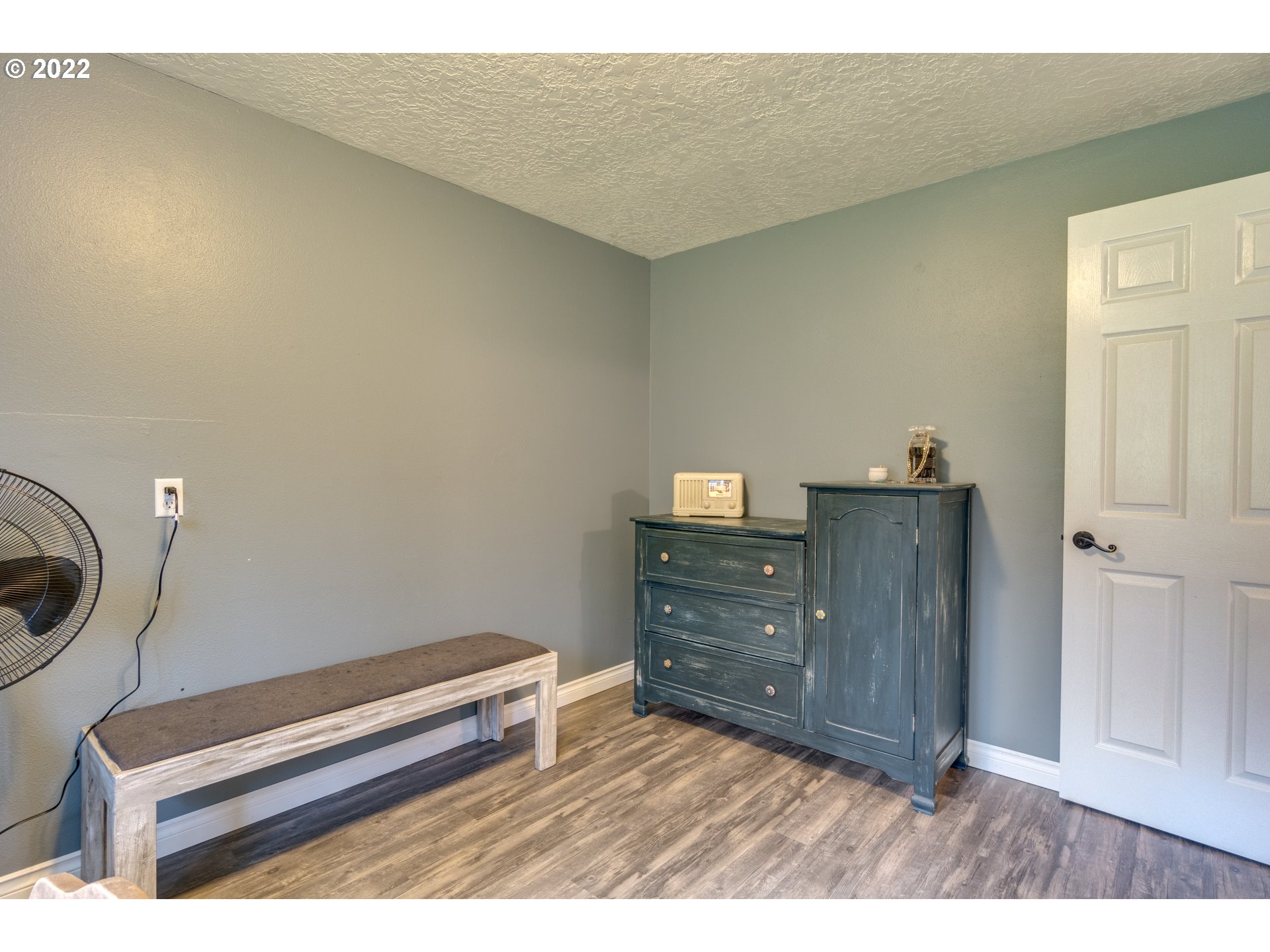 623 Ragland Road Longview, WA 98632 - Photo 12 of 30 a room with a dresser and a wooden floor