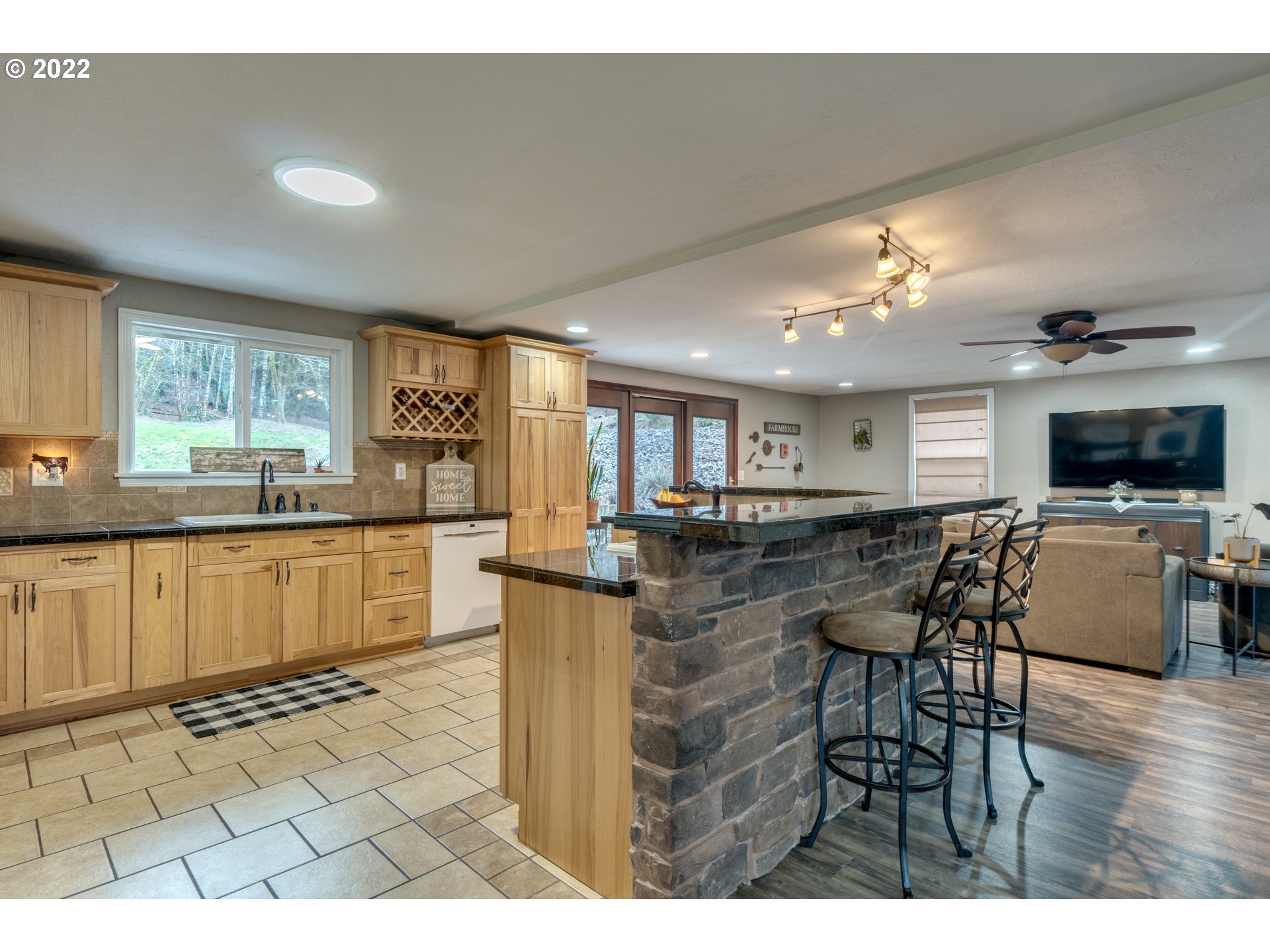 623 Ragland Road Longview, WA 98632 - Photo 24 of 30 a kitchen with stainless steel appliances kitchen island granite countertop a stove a sink a dining table and chairs
