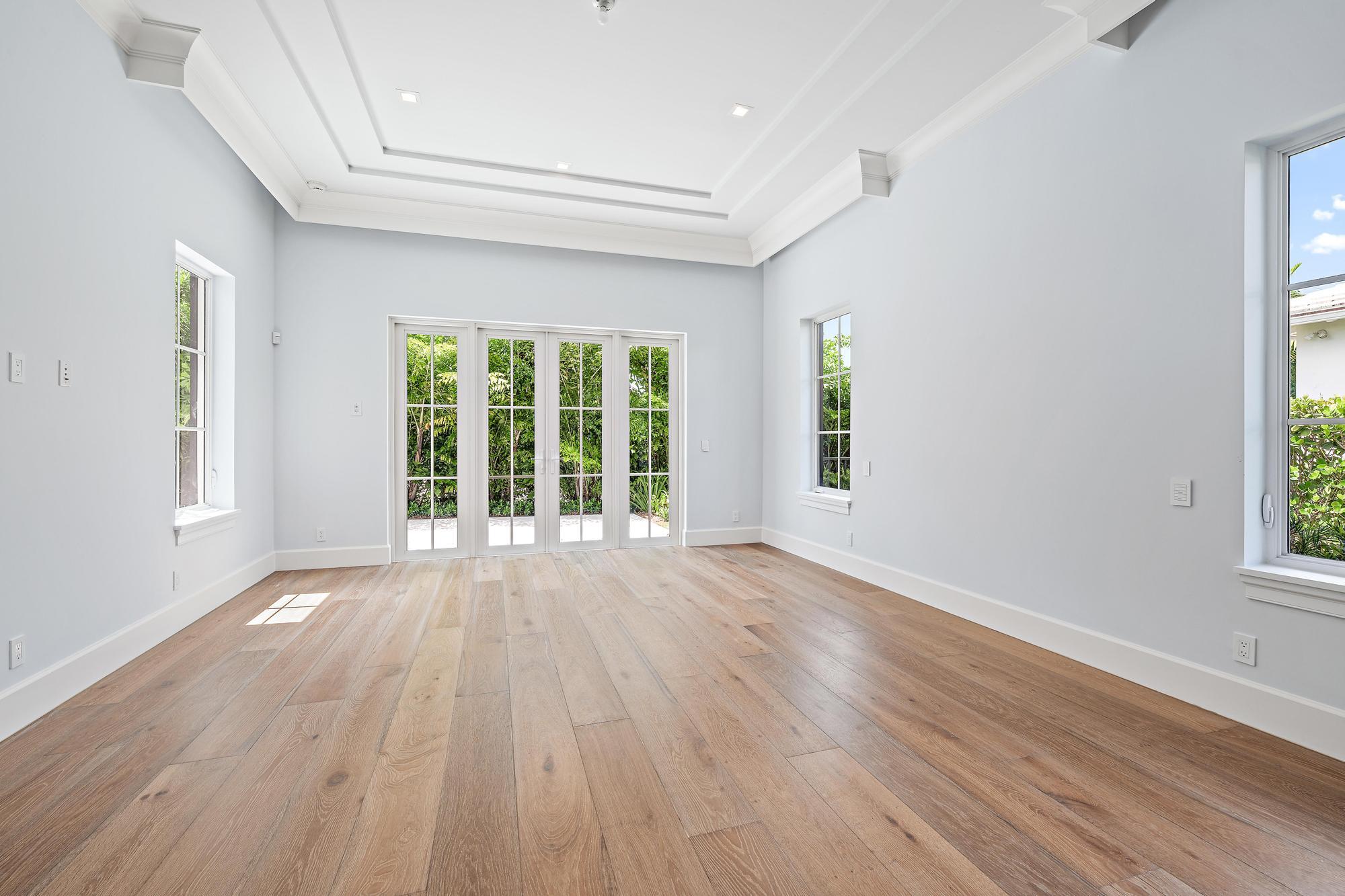 2914 Bluewater Cove Gulf Stream, FL 33483 - Photo 21 of 45 a view of an empty room with wooden floor and a window