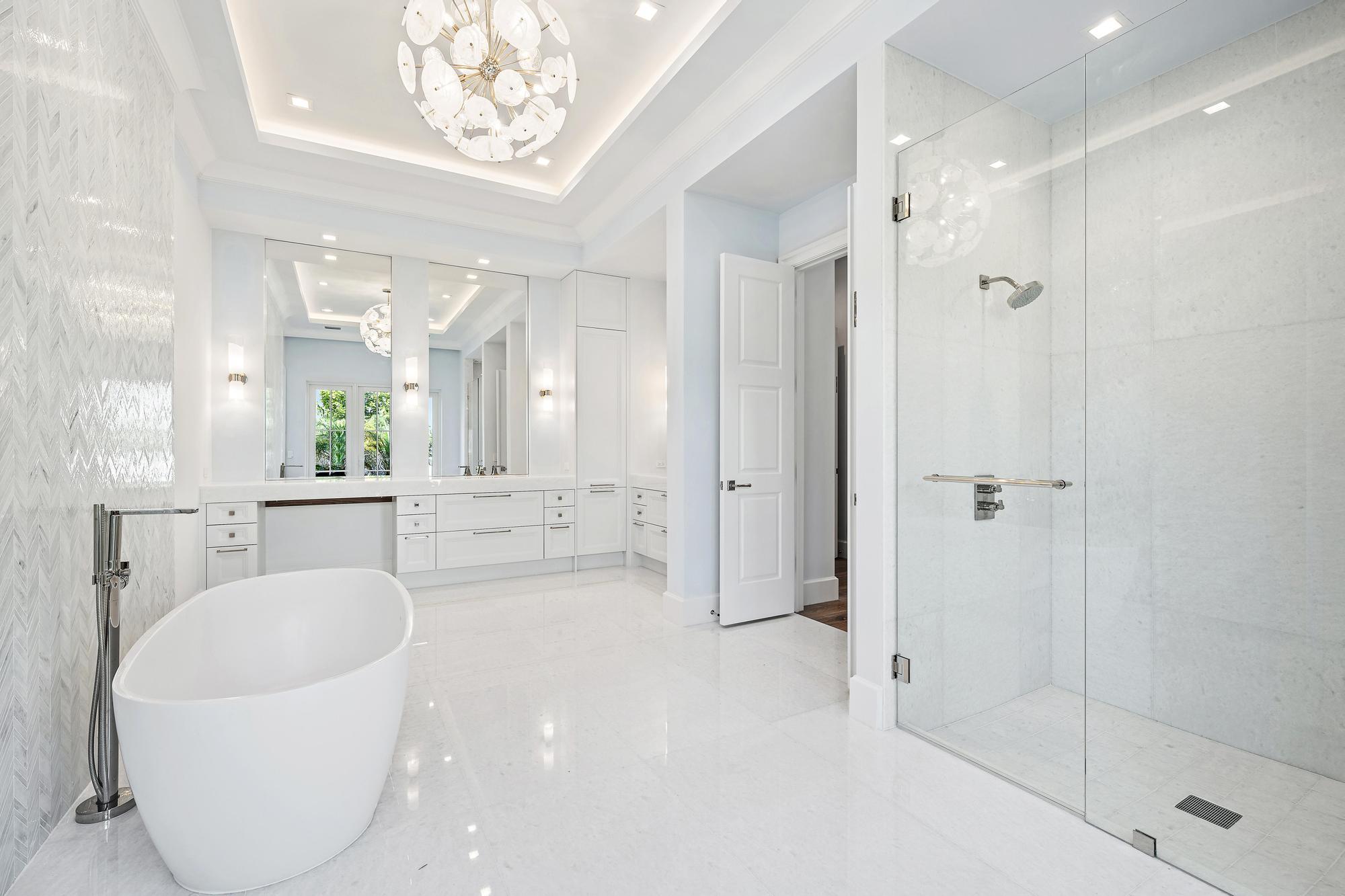 2914 Bluewater Cove Gulf Stream, FL 33483 - Photo 25 of 45 a large spacious bathroom with a granite countertop tub shower and mirror