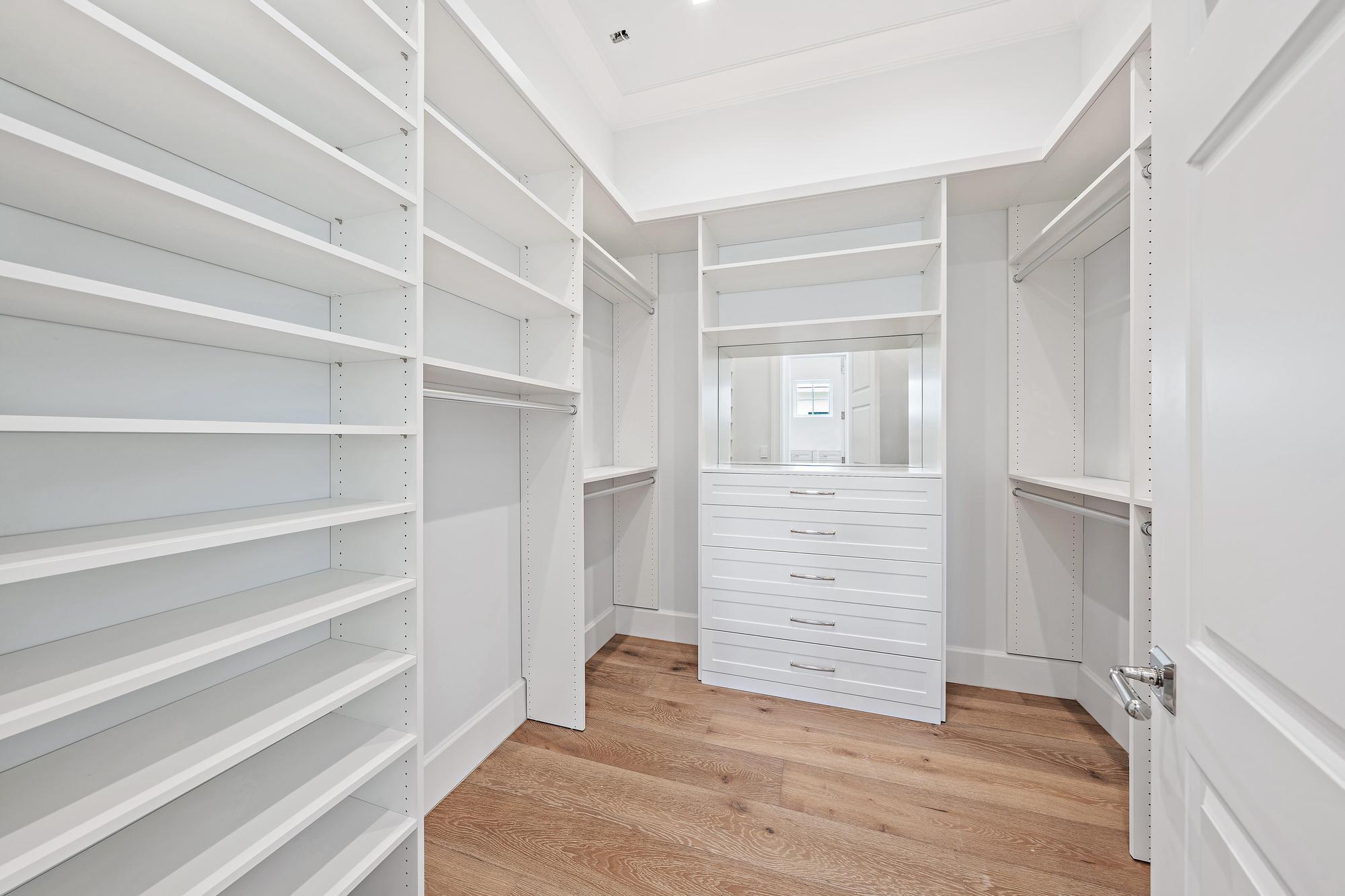 2914 Bluewater Cove Gulf Stream, FL 33483 - Photo 28 of 45 a view of walk in closet with empty racks
