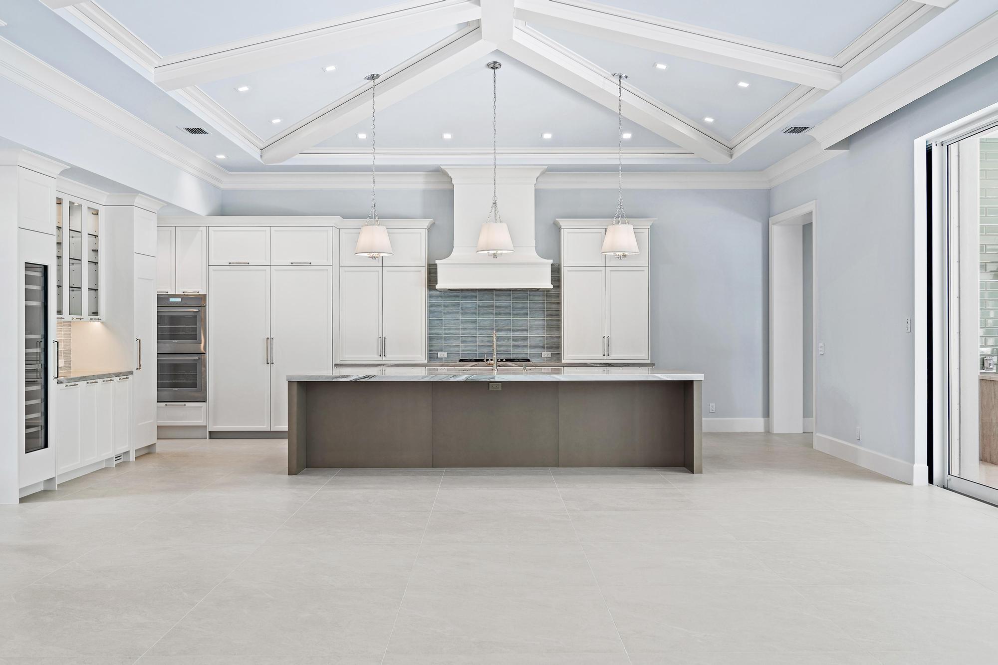 2914 Bluewater Cove Gulf Stream, FL 33483 - Photo 3 of 45 an open kitchen with granite countertop a refrigerator a sink and dishwasher