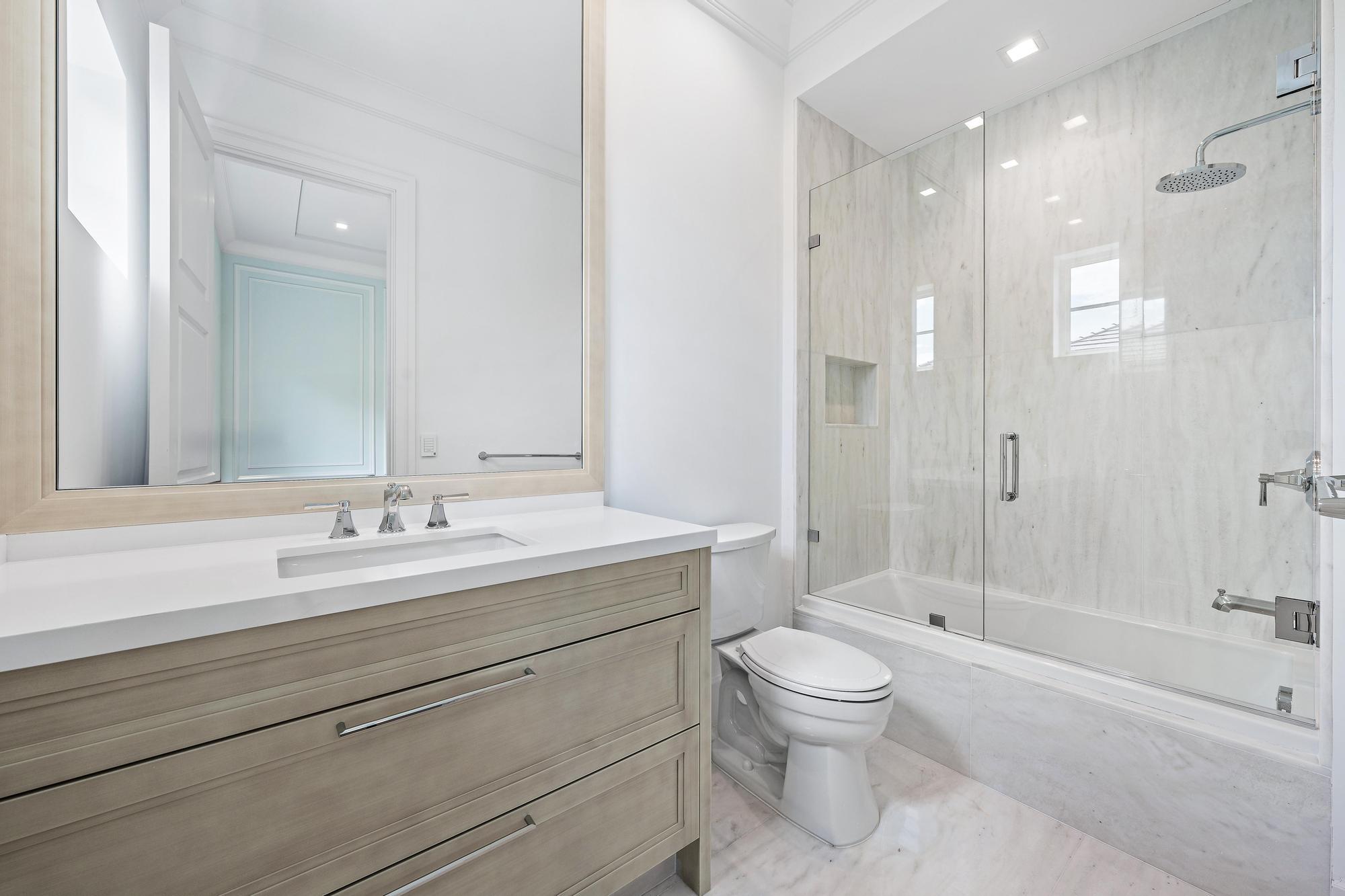 2914 Bluewater Cove Gulf Stream, FL 33483 - Photo 31 of 45 a bathroom with a sink a toilet and shower