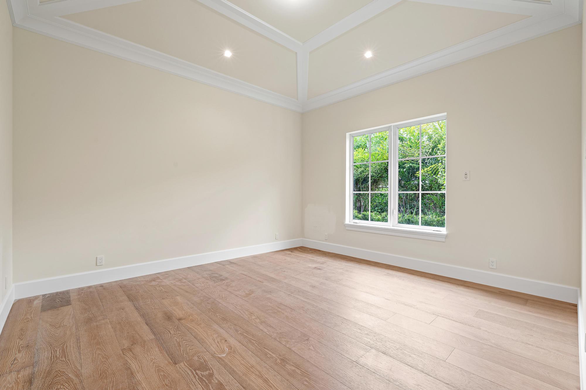 2914 Bluewater Cove Gulf Stream, FL 33483 - Photo 32 of 45 an empty room with wooden floor and windows