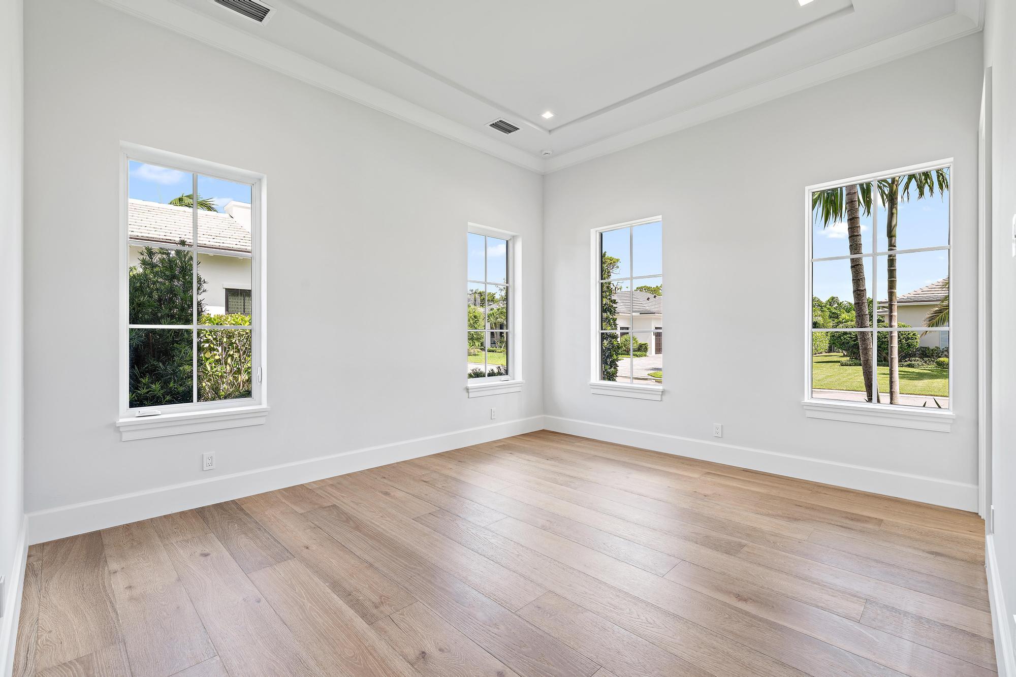 2914 Bluewater Cove Gulf Stream, FL 33483 - Photo 34 of 45 a view of an empty room with wooden floor and windows