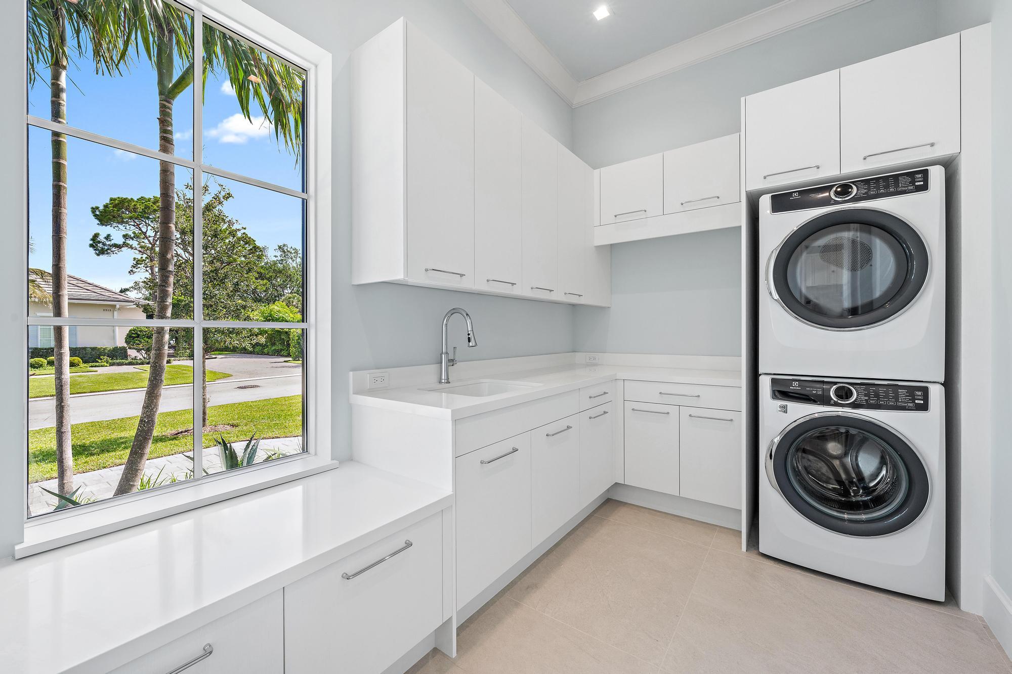 2914 Bluewater Cove Gulf Stream, FL 33483 - Photo 36 of 45 a utility room with sink dryer and washer