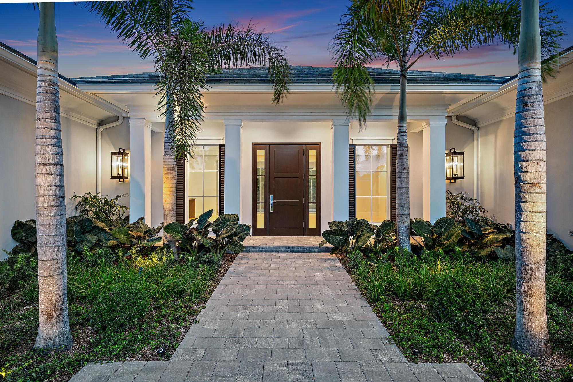 2914 Bluewater Cove Gulf Stream, FL 33483 - Photo 42 of 45 front view of a house with a small yard