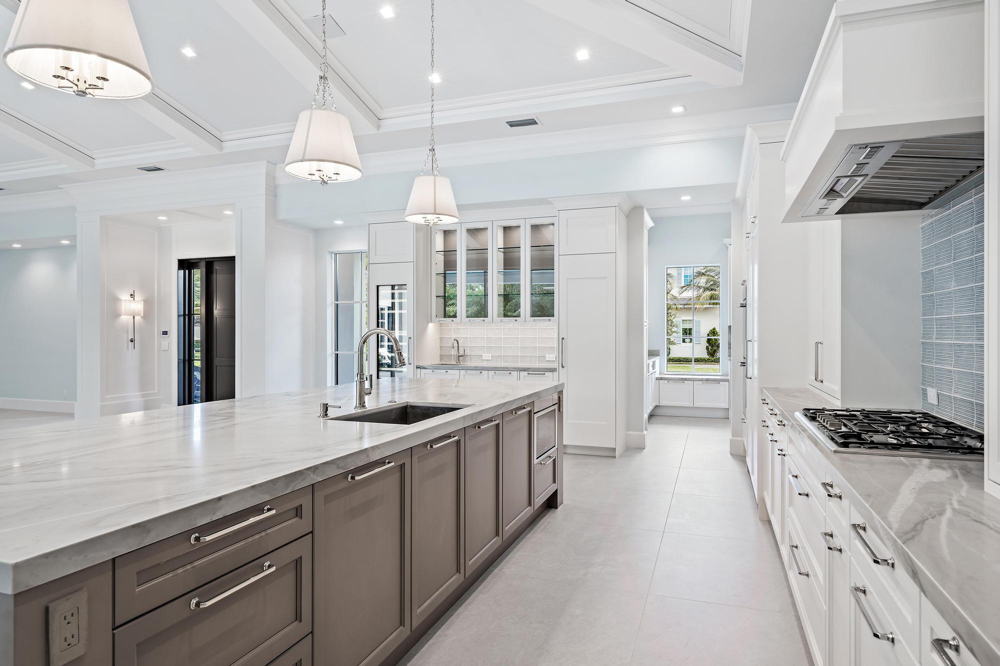 2914 Bluewater Cove Gulf Stream, FL 33483 - Photo 5 of 45 a kitchen with counter top space and a sink