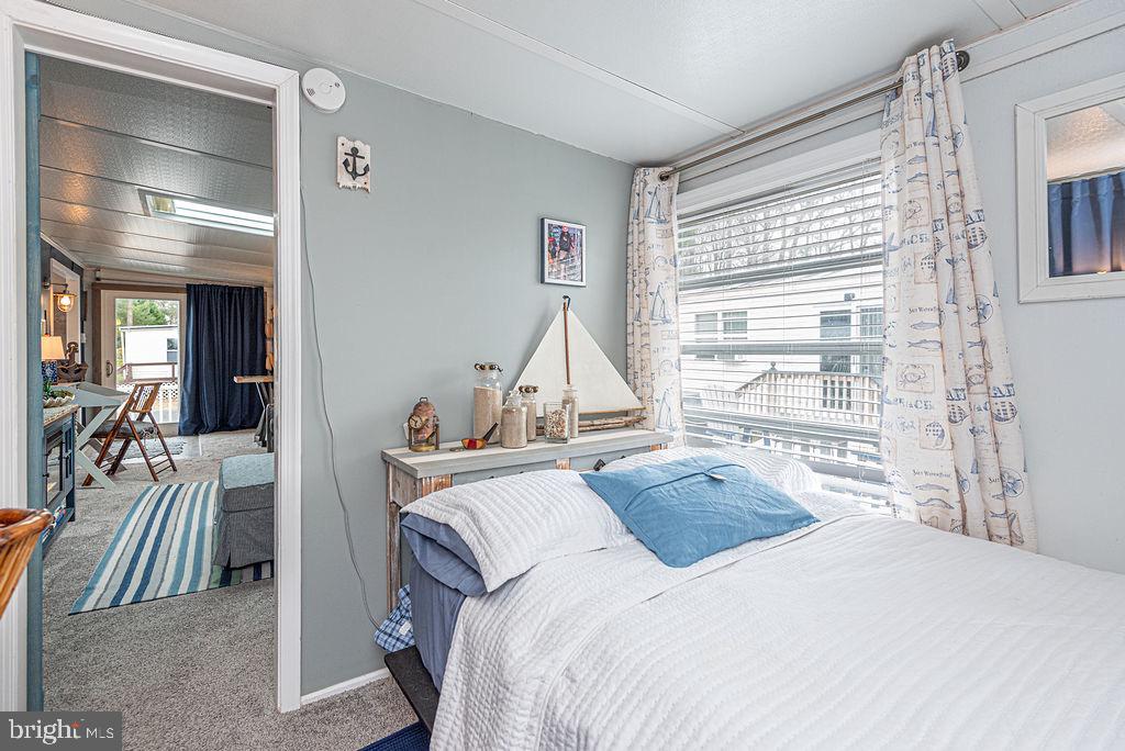 114 Skipjack Circle Berlin, MD 21811 - Photo 22 of 51 a bedroom with a bed and glass windows